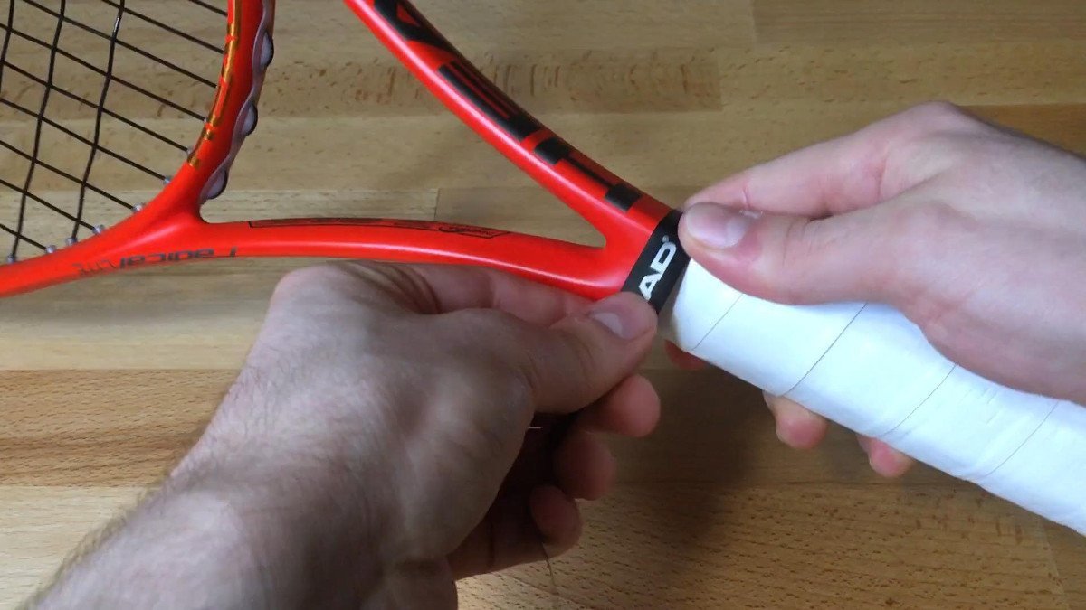 photo of a tennis racket during changing overgrip step 9