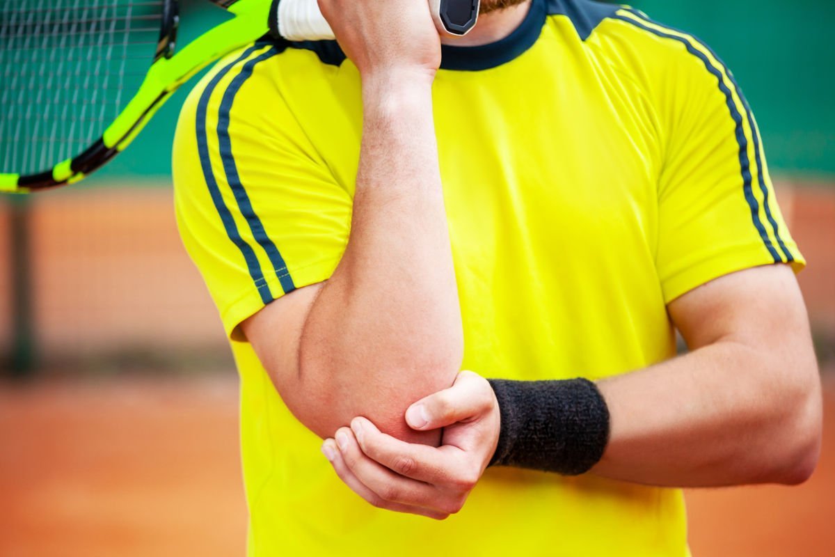 photo of a male tennis player with a tennis elbow